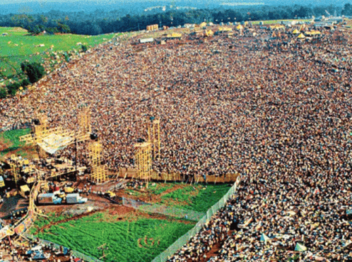 Which singer led Woodstock’s opening act in 1969?